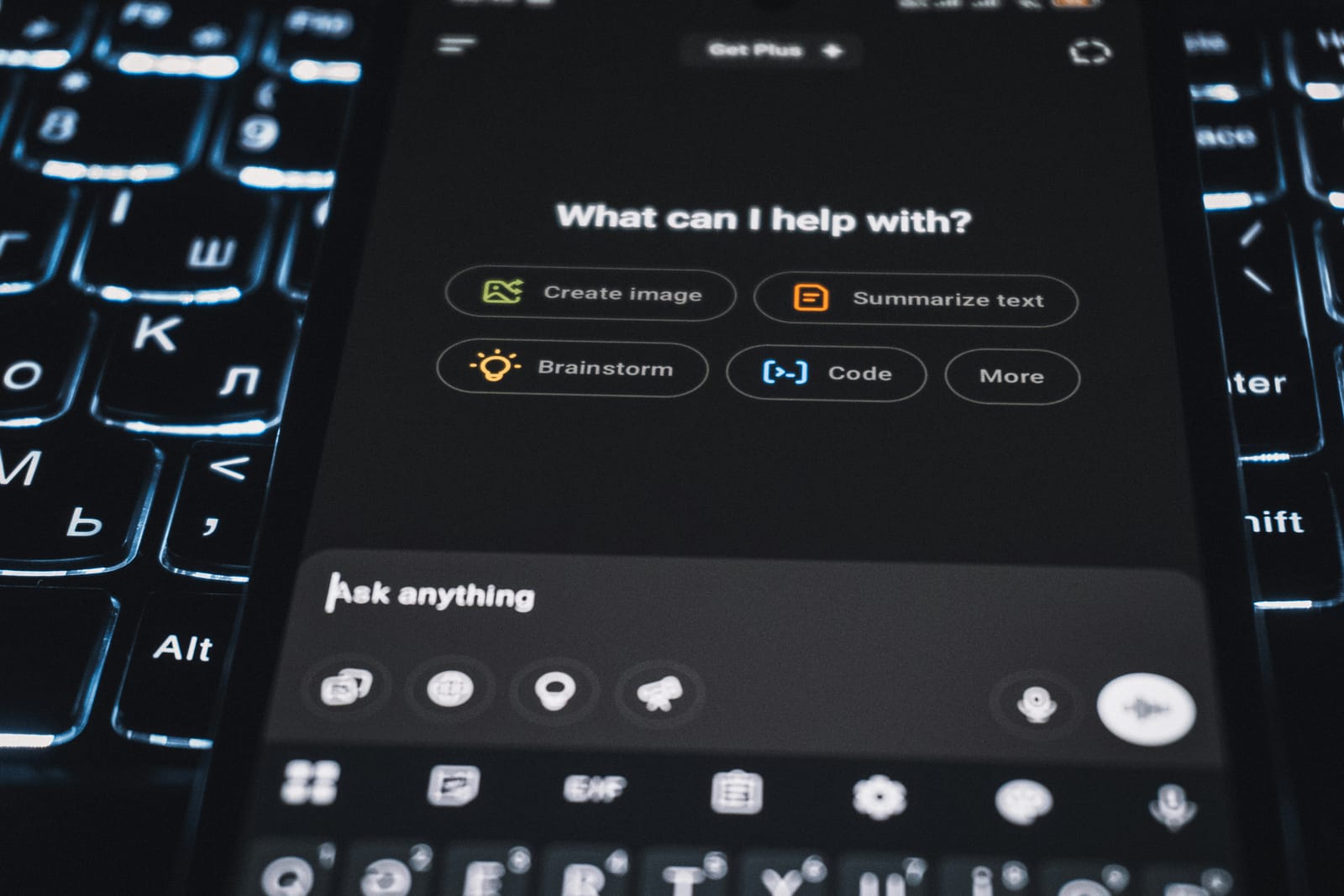 An AI assistant open on a phone resting on a backlit keyboard