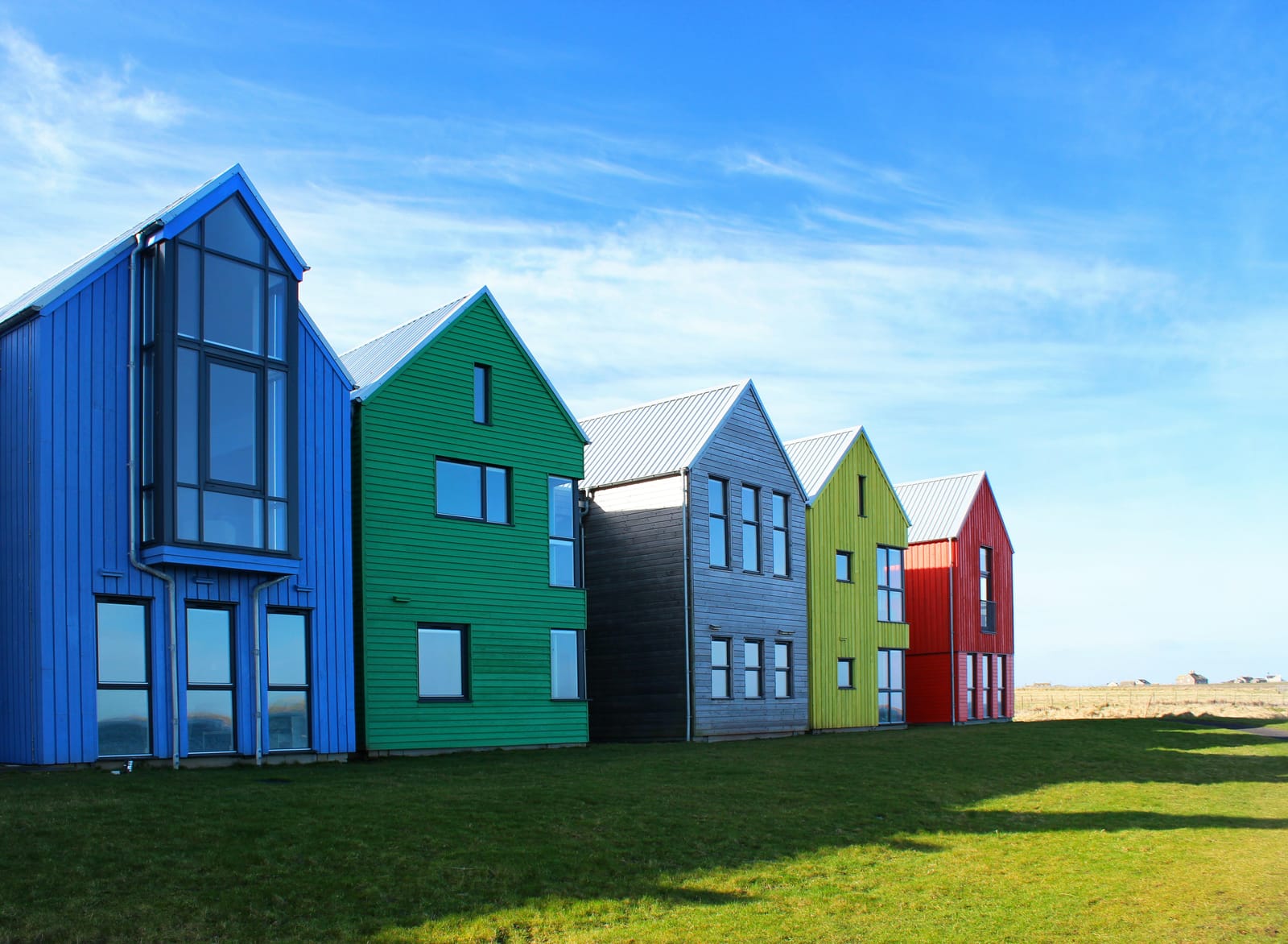 Row of modern modular housing units with coloured facades